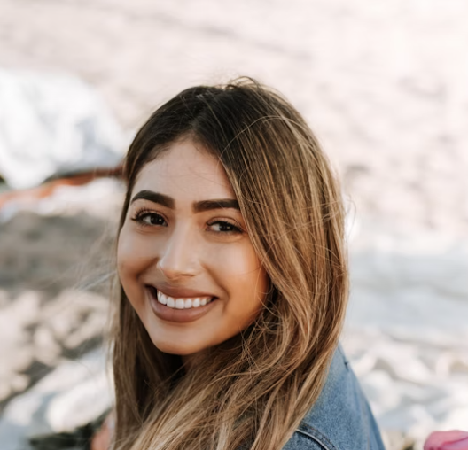 Woman smiling outdoors near beach